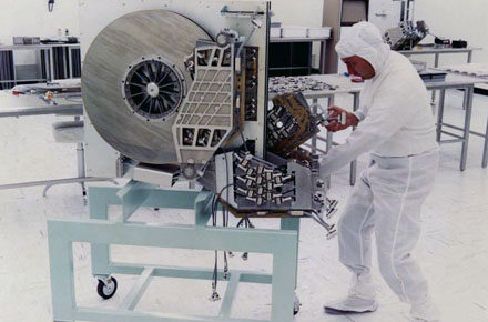 Antique Disk Man pushing humongous hard drive in a clean room