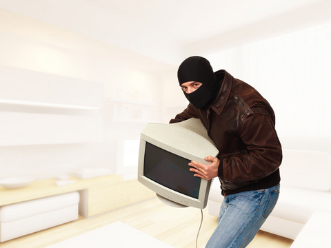 Burglar stealing computer monitor